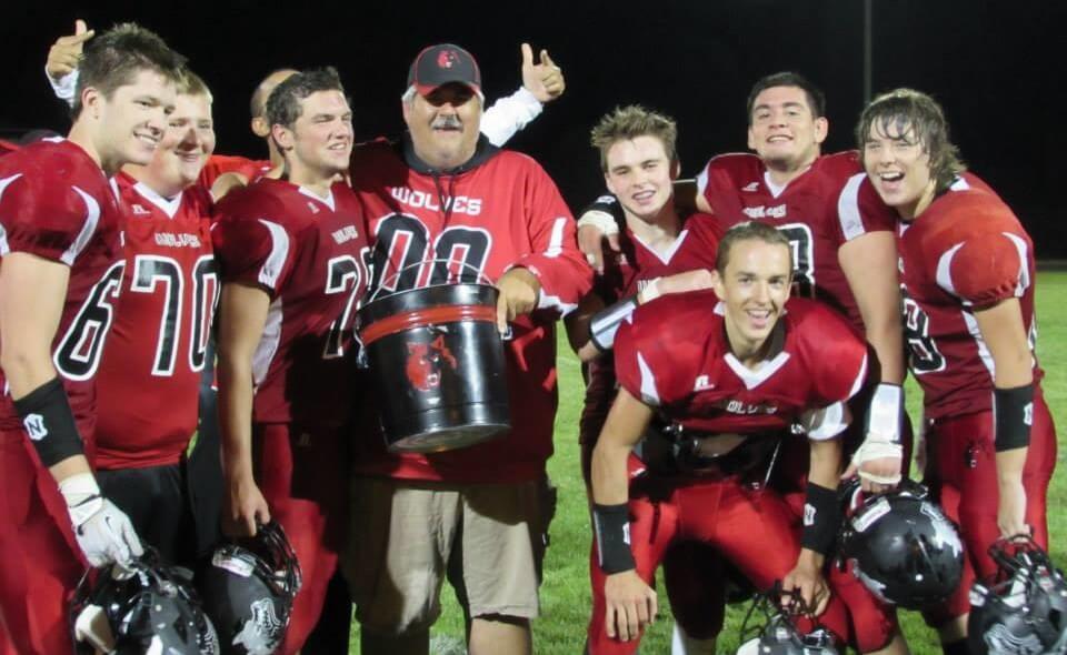 Coupville coach Tony Maggio, with the bucket, and a pack of Wolves.