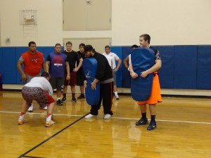 (Line Coach Alex Linnenkohl working with the OL)