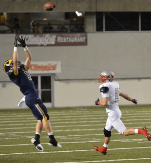 Timmy Haehl climbs the ladder to snatch an INT during the State Semi Finals.