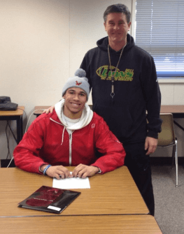 Jalani Phelps signing his LOI alongside Lynden coach Curt Kramme.